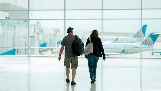Couple walking through an airport together