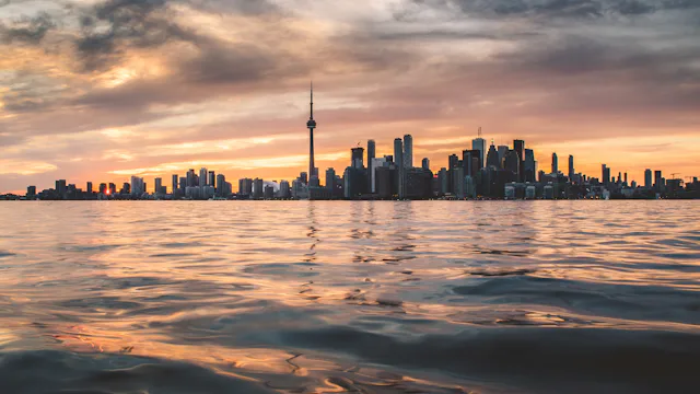 Toronto skyline with the CN Tower across Lake Ontario at golden hour